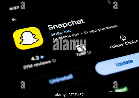 Snapchat App Listing Displayed on Smartphone Screen in Google Play Store Stock Photo