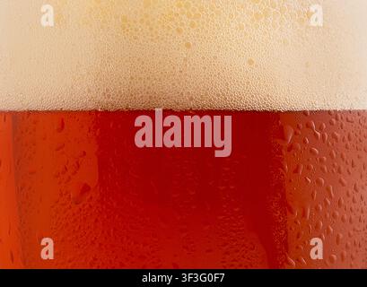 Beer background with bubble froth texture, pouring alcohol in glass, happy celebration party, holiday Stock Photo