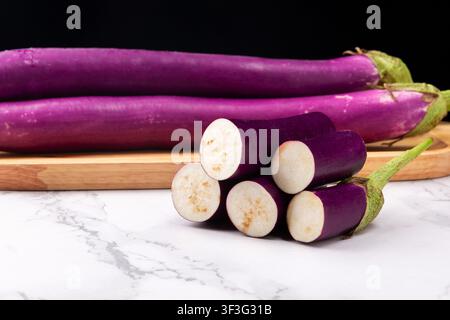 Fresh raw purple eggplant sliced aubergine asian nightshade vegetable Stock Photo