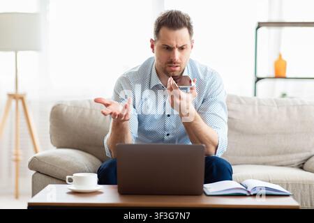 Adult handsome man using voice assistant on smartphone Stock Photo