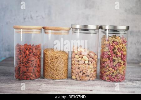Jars filled with various food items on a wooden table Stock Photo