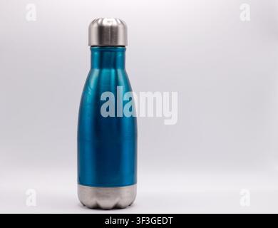 Blue reusable stainless steel water bottle with silver cap isolated on white background. Stock Photo