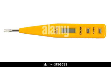Indicator screwdriver for determining the phase of the electric current. Yellow indicator screwdriver isolated on a white background. Stock Photo