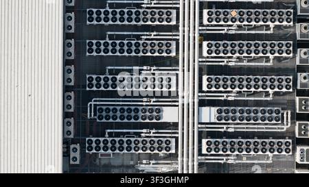 Aerial view of HVAC cooling systems on the rooftop of a data center, showing large scale computing infrastructure, server facility equipment and cloud Stock Photo