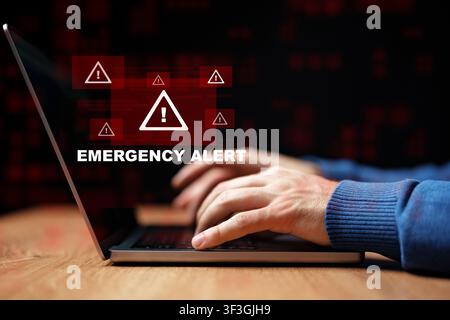 Emergency alert displayed on a laptop during a critical situation at night Stock Photo