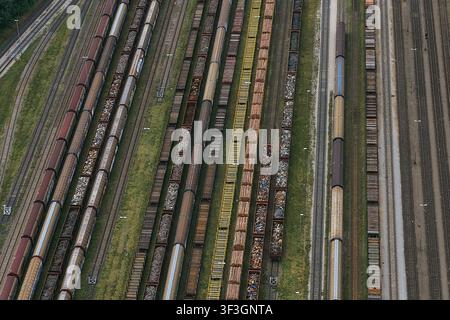 Aerial view of freight trains parked on multiple parallel tracks at the railway yard in Saalfeld, Thuringia, Germany. Stock Photo
