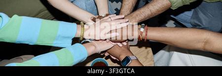 Diverse Team Joining Hands for Collaboration and Unity Stock Photo