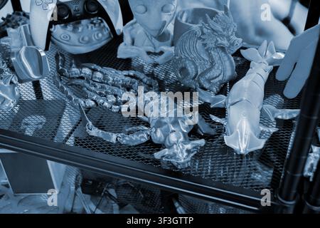Art models printed on 3D printer. Different objects created on 3D printer from molten plastic. 3D printed different objects. Modern new modern additive progressive technologies. 3D printing technology Stock Photo
