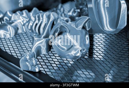 Art models printed on 3D printer. Different objects created on 3D printer from molten plastic. 3D printed different objects. Modern new modern additive progressive technologies. 3D printing technology Stock Photo