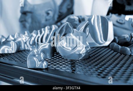 Art models printed on 3D printer. Different objects created on 3D printer from molten plastic. 3D printed different objects. Modern new modern additive progressive technologies. 3D printing technology Stock Photo