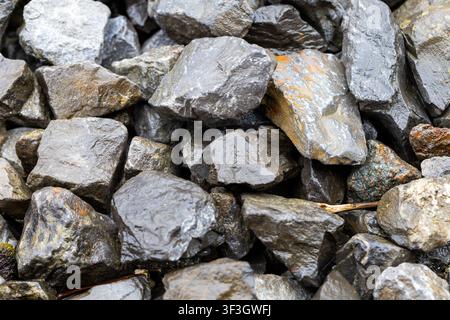 Natural grey stone texture formed by irregular rocks, suitable as a background or construction material concept. Stock Photo