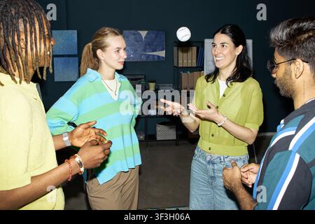 Diverse Adult Coworkers Collaborating during Team Meeting Stock Photo