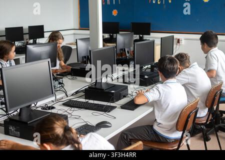 Elementary school students using desktop computers in computer lab Stock Photo