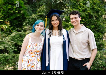 Siblings celebrating sister on her graduation day Stock Photo