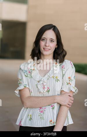 Portrait of a smiling brunette woman outside Stock Photo