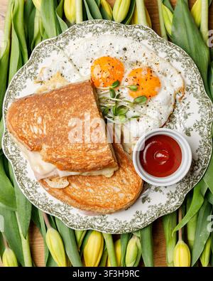 English breakfast on a vintage plate against a tulip background, isolated. Professional studio lighting. Top view. Stock Photo
