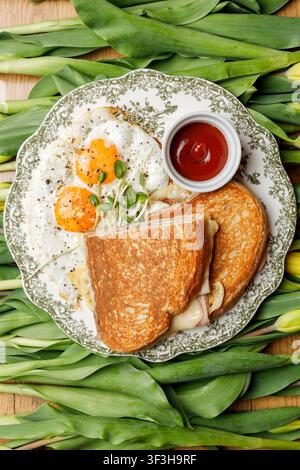 English breakfast on a vintage plate against a tulip background, isolated. Professional studio lighting. Top view. Stock Photo