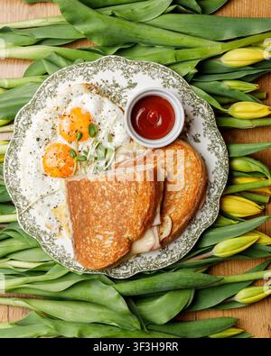 English breakfast on a vintage plate against a tulip background, isolated. Professional studio lighting. Top view. Stock Photo