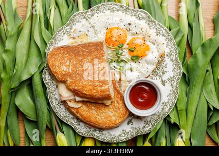 English breakfast on a vintage plate against a tulip background, isolated. Professional studio lighting. Top view. Stock Photo
