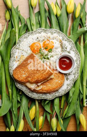 English breakfast on a vintage plate against a tulip background, isolated. Professional studio lighting. Top view. Stock Photo