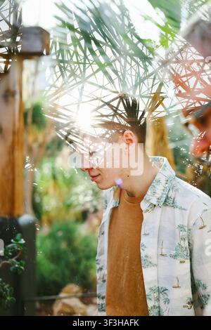Young Man Using Tablet Creative portrait of a caucasian male with one eye obscured by spring ...
