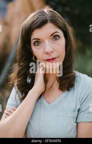 Woman with green eyes looks directly at the camera Stock Photo