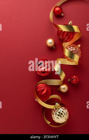 Christmas ornaments and a golden ribbon creating a festive and celebratory border on a rich red background, symbolizing holiday cheer, luxury, and gif Stock Photo