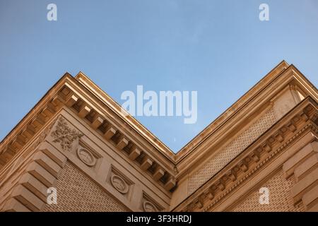 Historic Building Corner with Crescent Moon in Blue Sky Stock Photo