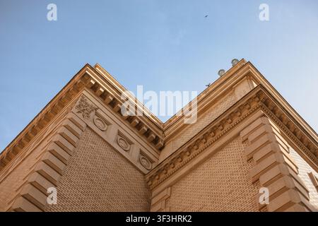 Historic Building Corner with Crescent Moon in Blue Sky Stock Photo