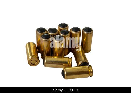 Small pile of non lethal handgun ammunition cartridges with brass casings and black rubber bullets isolated on white background. Stock Photo