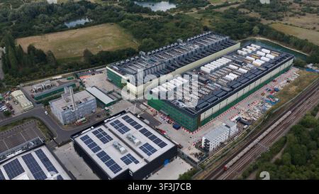 Aerial view of a large-scale data center facility and expansion site in East London. Highlights high density server housing, renewable energy infrastr Stock Photo