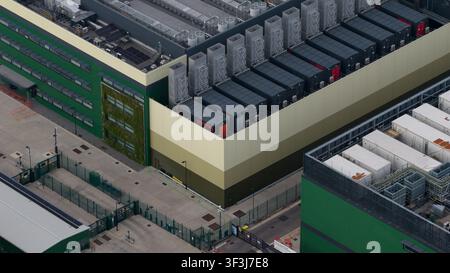 Aerial view of a large-scale data center facility and expansion site in East London. Highlights high density server housing, renewable energy infrastr Stock Photo