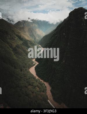 Aerial view of the Urubamba River winding through a deep, lush green ...