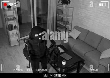 Thief With Crowbar Entering House View From Camera Stock Photo