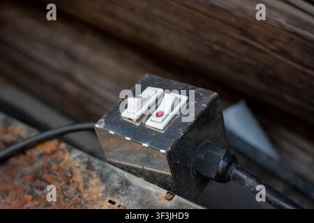 Industrial double toggle switch box on a rusty surface Stock Photo