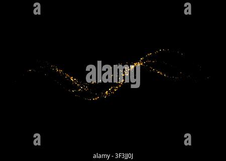 Gold glitter particle wave creates a flowing light trail with sparkle dots on an abstract black background Stock Vector