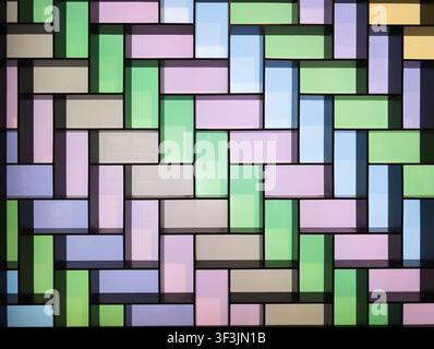 Abstract geometric background of colorful rectangular glass panels arranged in modern mosaic wall pattern with vibrant translucent blocks for contempo Stock Photo