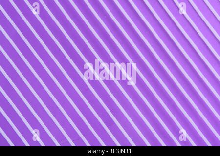 Abstract bright purple diagonal ribbed background texture with parallel white striped pattern Stock Photo