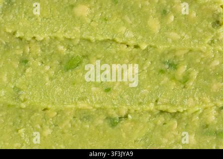 Top view of healthy organic avocado puree structure, seamless culinary pattern Stock Photo