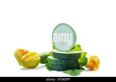 Fresh sliced zucchini with yellow blossoms on white isolated background . Stock Photo