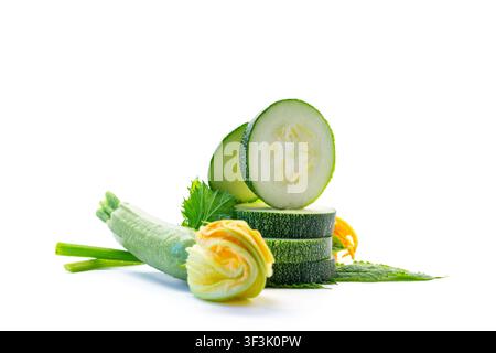 Organic zucchini slices with green leaves on clean white background . Stock Photo