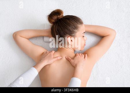 View above of young woman getting back massage Stock Photo