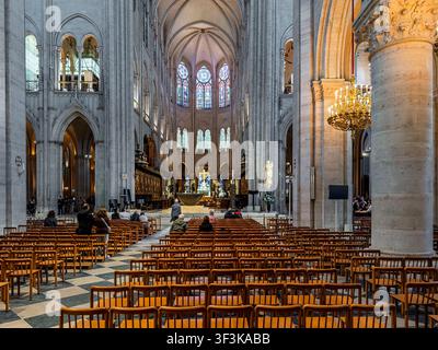 Rows of individual moveable wooden chairs in the central nave of Notre-Dame Cathedral a medieval Catholic cathedral, Île de la Cité  Paris, France Stock Photo