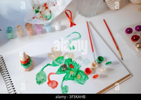 Colorful painting activity with brushes and paint on a table with decorations Stock Photo