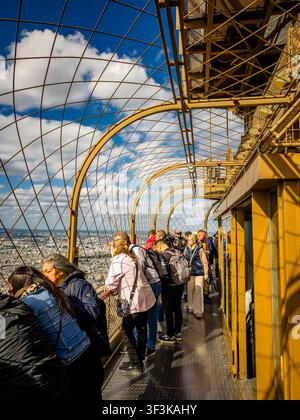 People admiring the view from the summit of  of The Eiffel Tower which sits 276 meters (906 feet) above the ground in Paris,France Stock Photo