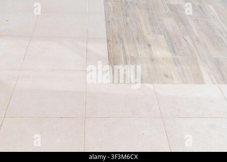 A seamless blend of contemporary ceramic tiles and realistic wood-effect flooring creates a stylish and durable surface Stock Photo