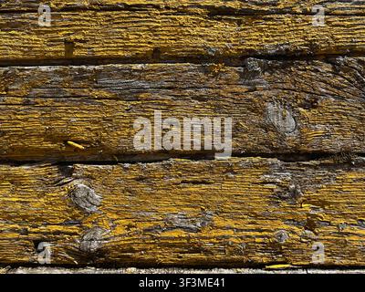 weathered yellow painted wood forming seamless rustic texture background Stock Photo