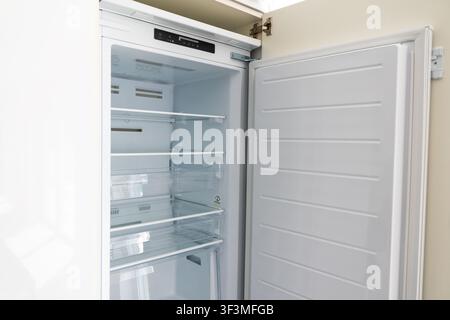 A clean, empty refrigerator interior with glass shelves and drawers, ready for groceries Stock Photo
