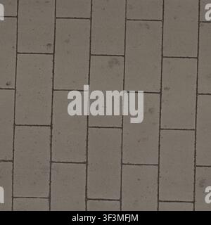 A top-down view of large, gray rectangular concrete tiles forming a modern pathway. Stock Photo