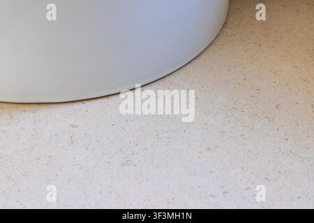 Abstract detail of a soft, rounded edge contrasting with a speckled, granular surface Stock Photo